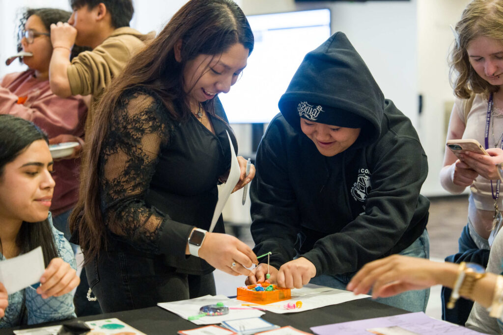 Students at a table participating in arts and crafts.