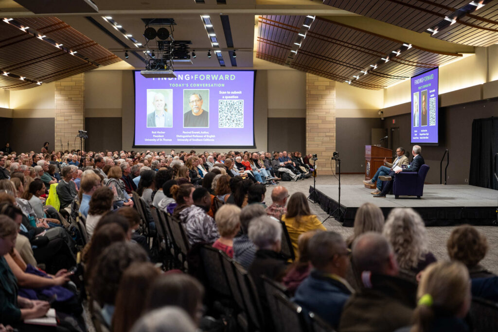 A view of the at-capacity audience watching Percival Everett on stage.