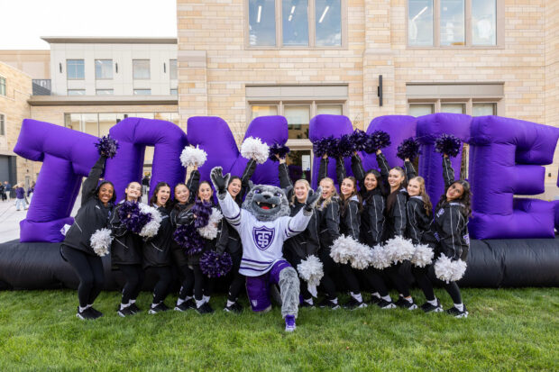 The Cheer Team poses for a photo with Tommie the macot during Purple on the Plaza