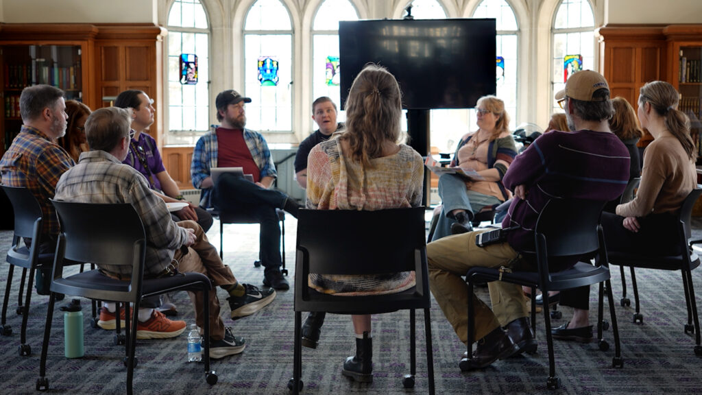 A group sits together, engaged in a story circle.