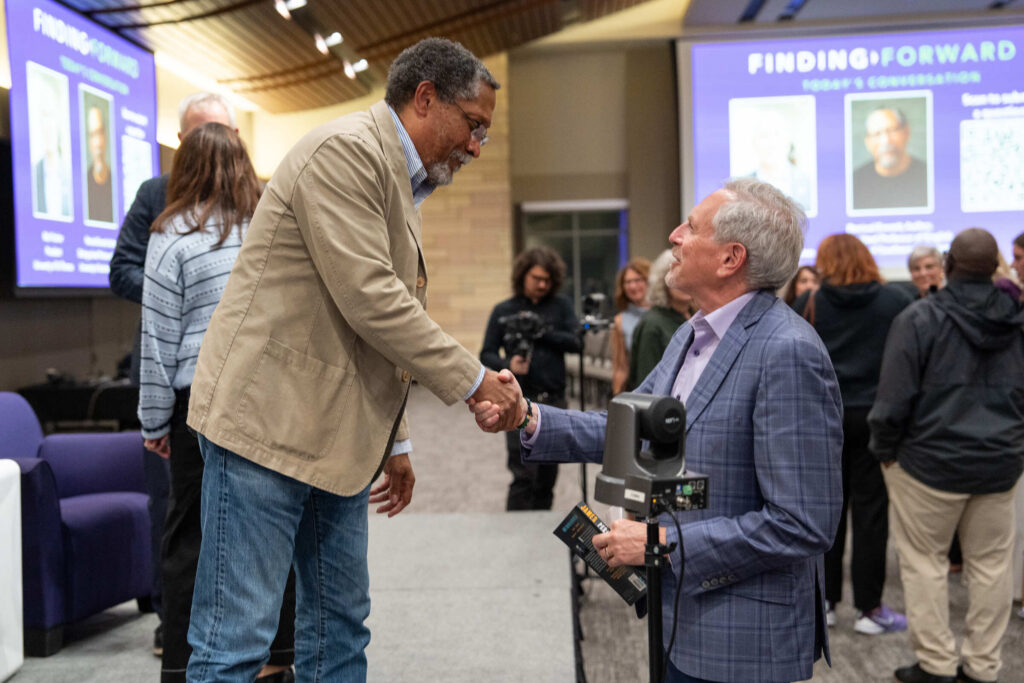 Percival Everett Shakes hands with Bill Tolman.