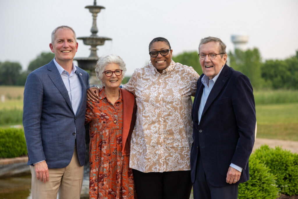 President Vischer, Kathy Dougherty, Dean Buffy Smith and Mike Dougherty pose for a photo outside.