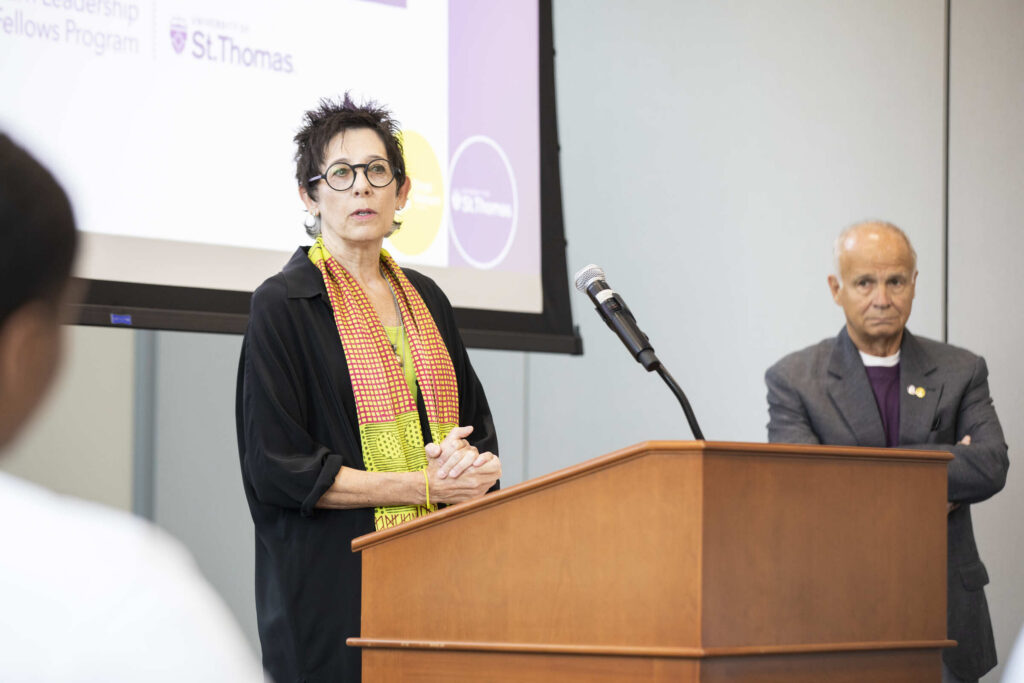 Roberta Walburn speaks during the Ciresi Walburn Leadership Fellows Induction and Pinning Ceremony as Mike Ciresi looks on