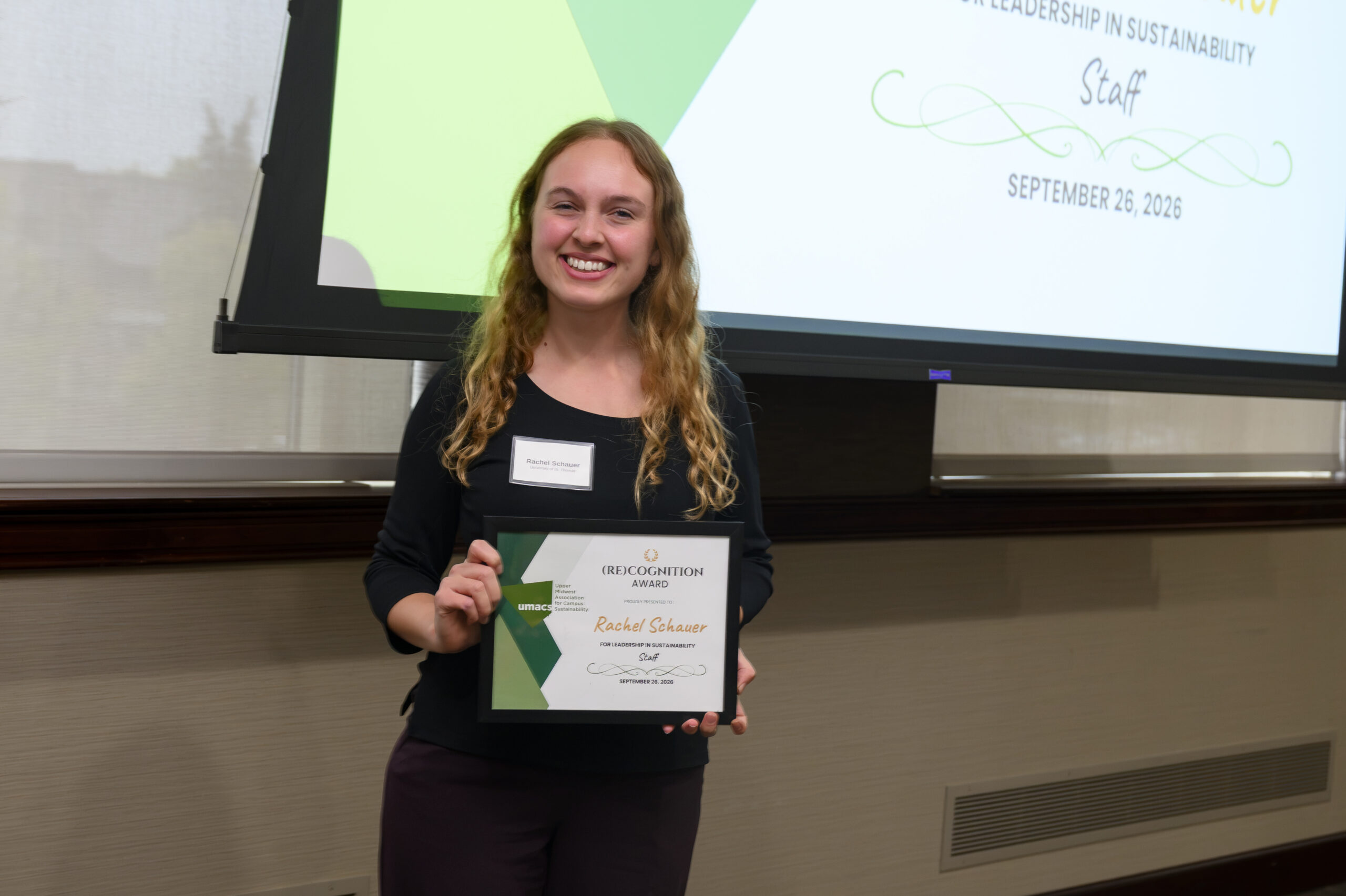 Rachel Schauer receiving the 2026 Staff Member (Re)Cognition Award from the Upper Midwest Association for Campus Sustainability (UMACS).