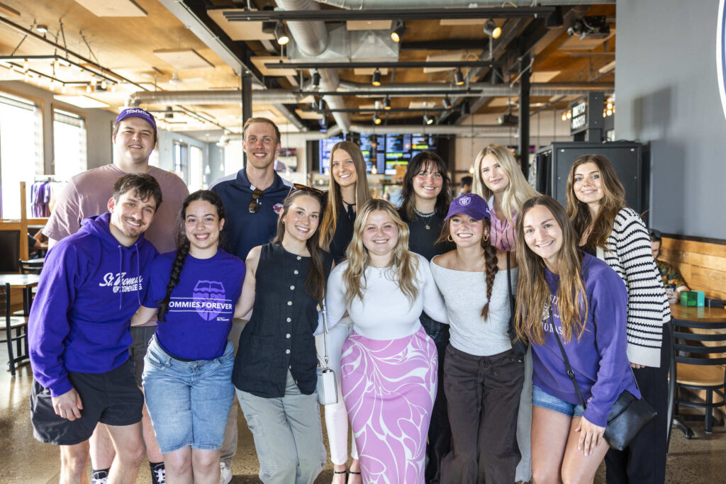 A group photo of alumni gathering together at Hops and Hype at Insight Brewing.