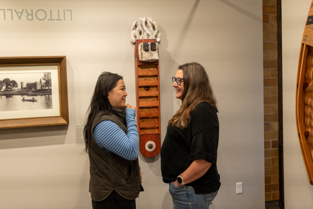 Guests talking about work inside a gallery.