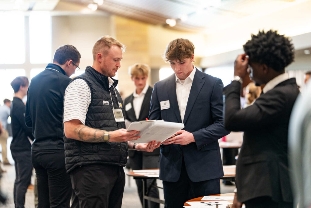 Jack Berg speaks with a recruiter at the reverse career fair.