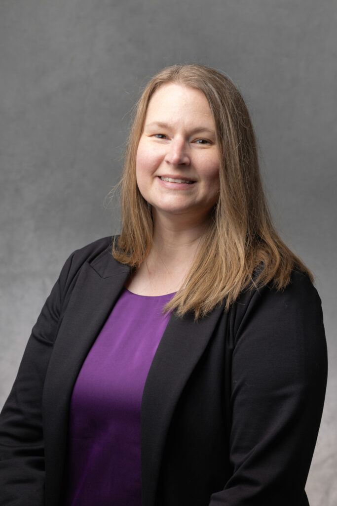 Kari Rusch-Curl smiles for a headshot.