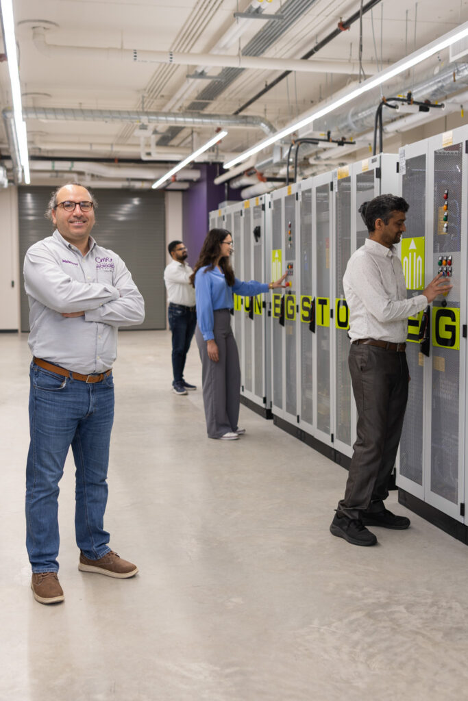 Mahmoud Kabalan poses with equipment in new microgrid.