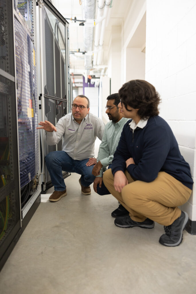 Mahmoud Kabalan shows students the equipment in new microgrid.