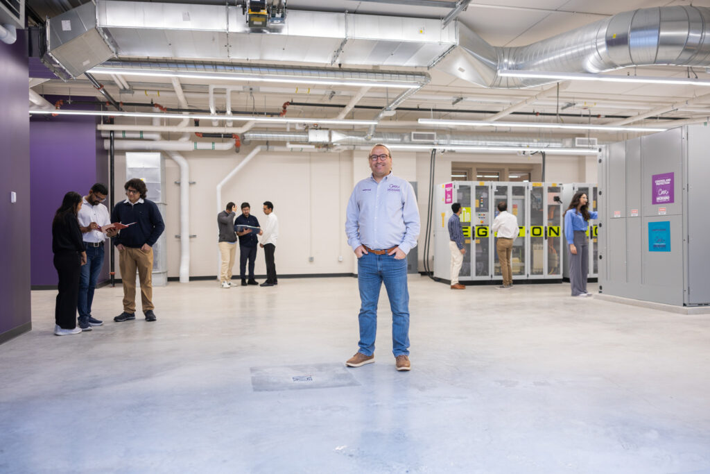 Mahmoud Kabalan poses with equipment in new microgrid.