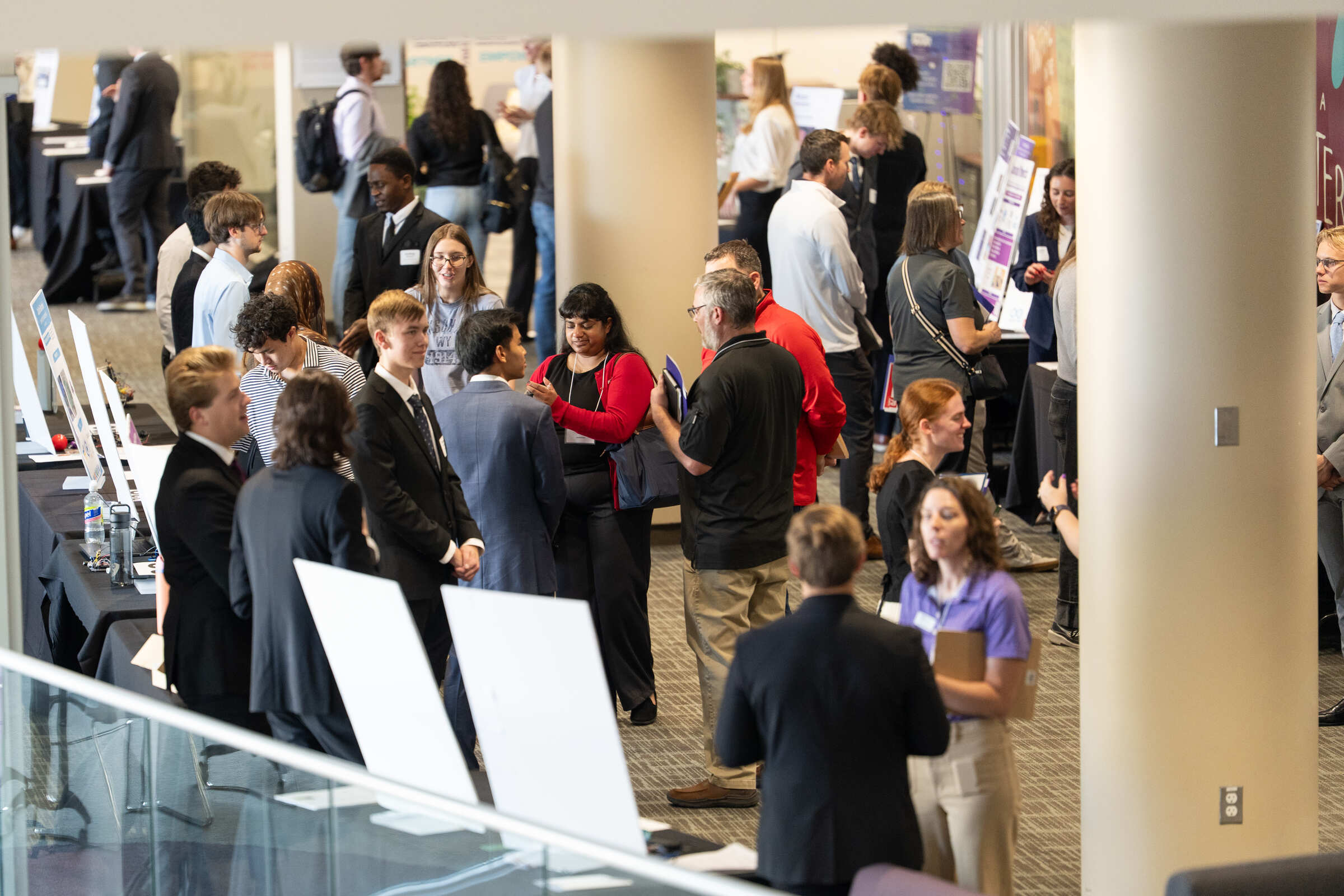 A wide shot of the reverse career fair with students and recruiters interacting with each other.