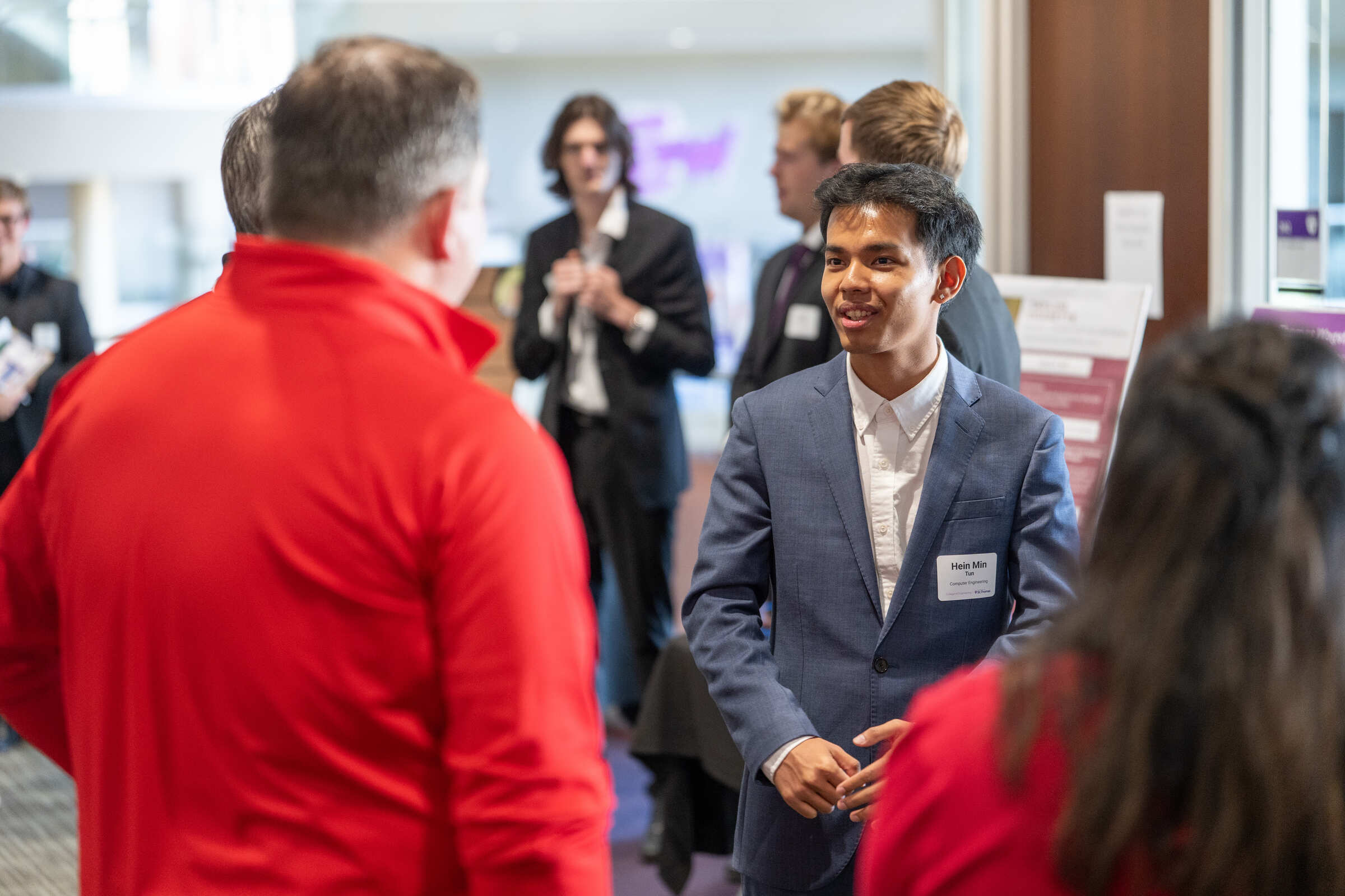 Employers meet with a student at the reverse career fair.