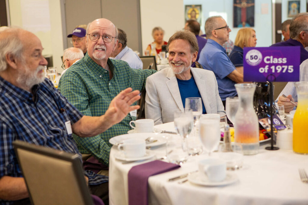 Three Members of the Old Guard Class of 1975 sit at a table together.