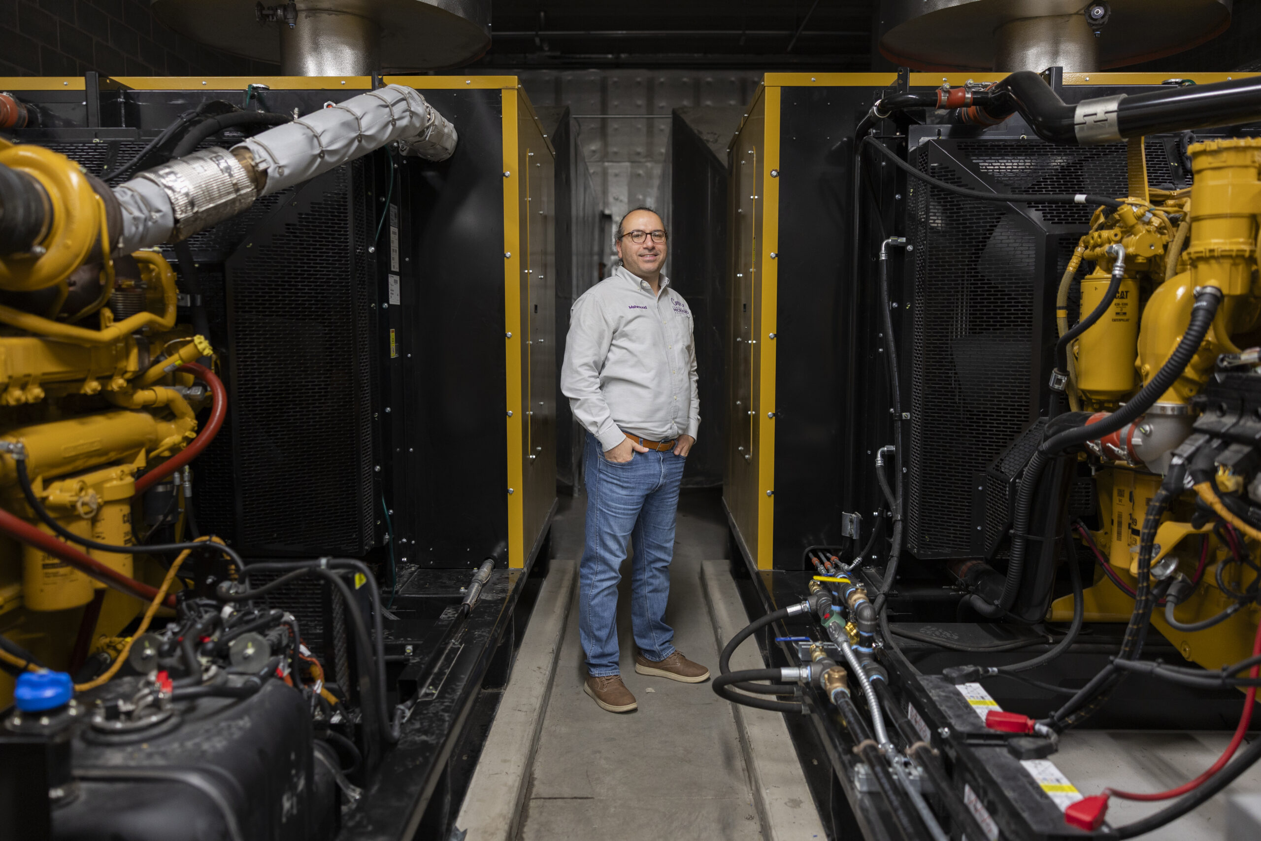 Mahmoud Kabalan poses with equipment in new microgrid.