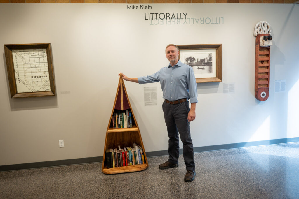 Mike Klein poses by his artwork titled "Littorally."