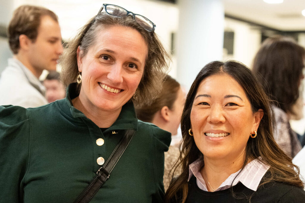 Two alums gather for a photo at an alumni event.