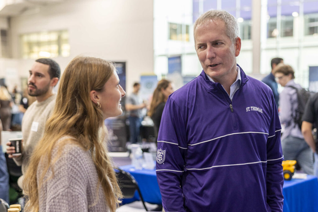 President Rob Vischer speaks with a student.
