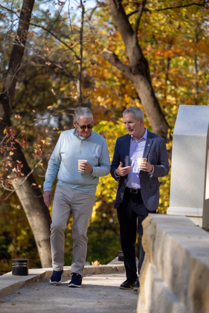 Joe Ryan '80 and President Rob Vischer cross a bridge in the new Grotto.