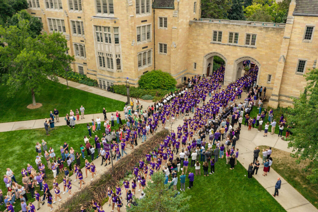 Students march through the Arches.